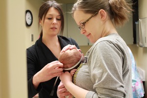 Nurse measuring babies head